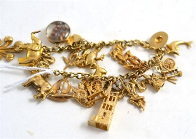 Lot 268 - A curb and lock bracelet hung with 22 charms