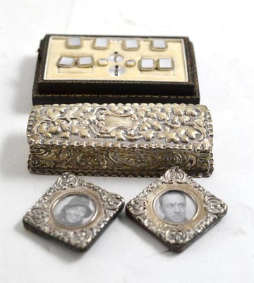 Lot 271 - A silver rectangular box, two silver mounted miniature photograph frames, a cased set of studs