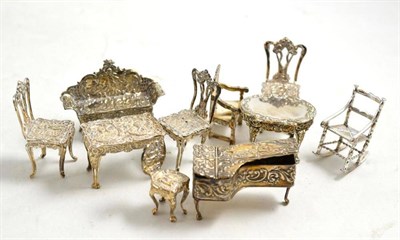 Lot 272 - A miniature set of three silver chairs, table and a sofa, a miniature silver piano, three...