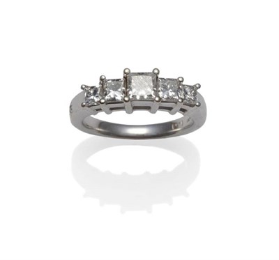 Lot 261 - A Princess Cut Diamond Five Stone Ring, the graduated diamonds in white claw settings, to a...