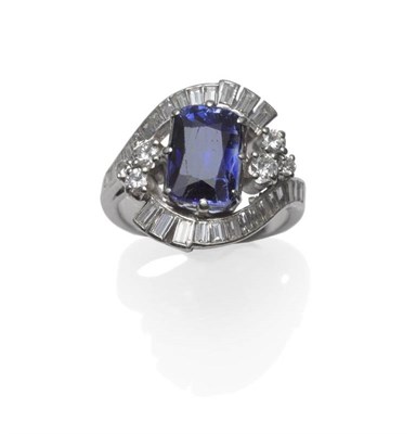 Lot 263 - A Sapphire and Diamond Cluster Ring, circa 1940, the cushion shaped mixed cut sapphire with a...