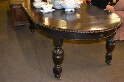 Lot 347 - An oak telescopic dining table with cup and cover supports