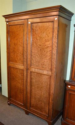 Lot 360 - An early 19th century plum pudding mahogany double wardrobe