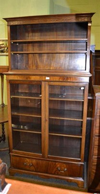 Lot 375 - A mahogany glazed bookcase with open upper section, with blind fret carved frieze above...