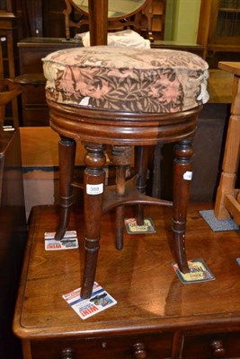 Lot 388 - A Victorian walnut revolving piano stool