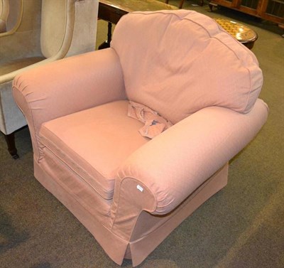 Lot 405 - A large upholstered armchair with loose covers