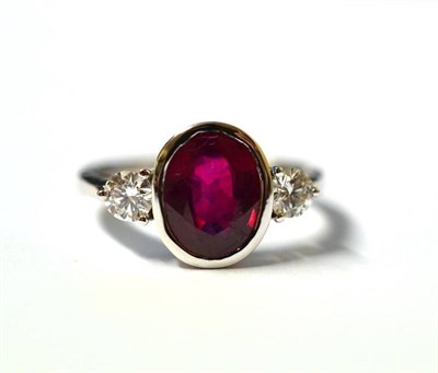 Lot 272 - A Glass Filled Ruby and Diamond Three Stone Ring, the oval mixed cut red stone in a white...