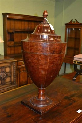 Lot 415 - A mahogany cutlery urn, in George III style, with ovoid finial, over a rising lid with...