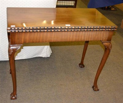 Lot 425 - Mahogany fold-over card table on claw and ball feet