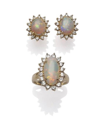Lot 278 - An Opal and Diamond Cluster Ring, the oval cabochon opal within a border of sixteen round brilliant