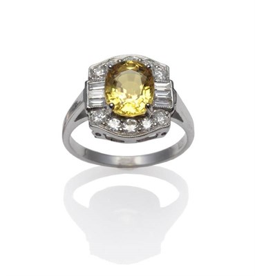 Lot 288 - A Yellow Sapphire and Diamond Cluster Ring, the oval mixed cut yellow sapphire within a border...