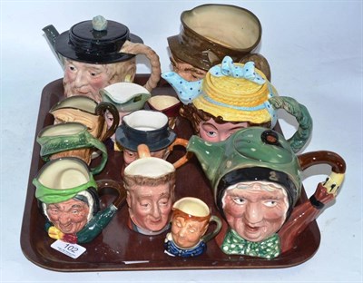 Lot 102 - Twelve assorted Beswick and Royal Doulton character jugs and teapots