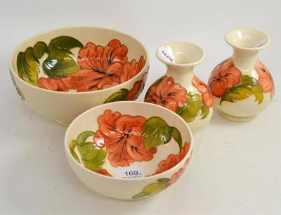 Lot 169 - Four Moorcroft coral Hibiscus pattern items including a large Moorcroft bowl, 20 cm wide,...