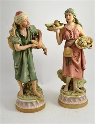 Lot 183 - A pair of Royal Dux porcelain figures of an Arab water carrier and a fruit seller (a.f.)