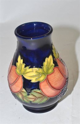 Lot 195 - A Moorcroft small plum and raspberry vase