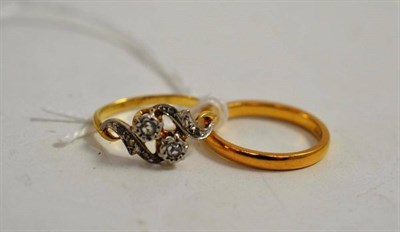 Lot 199 - A 22ct gold band ring and a diamond two stone twist ring