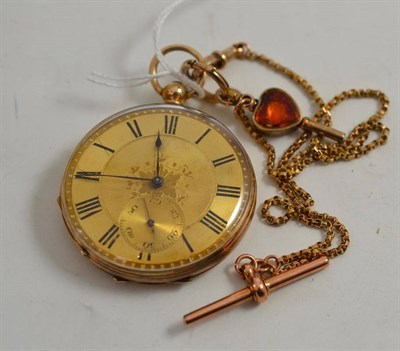 Lot 212 - Open faced pocket watch, stamped 14k on a watch chain