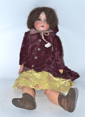 Lot 239 - Bisque socket head doll with yellow floral dress and plum coloured coat