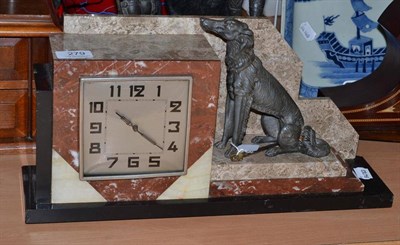 Lot 279 - An Art Deco marble mantel timepiece surmounted by a bronzed spelter seated Borzoi