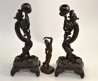 Lot 335 - A pair of Japanese bronze candlesticks modelled as dragons on raised bases and an Indian bronze...