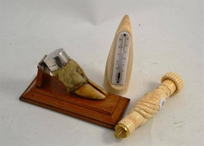 Lot 336 - A silver mounted deer's hoof letter clip on an oak plinth, a tusk thermometer and a parasol handle