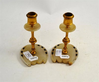 Lot 342 - A pair of gilt brass and onyx horse hoof candlesticks