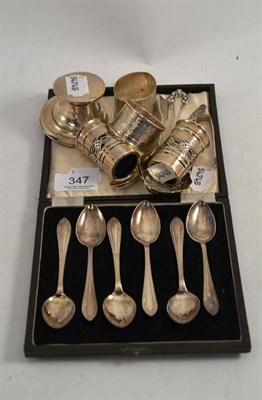 Lot 347 - Case set of six silver teaspoons, silver napkin rings, pair of silver pepperettes, silver...