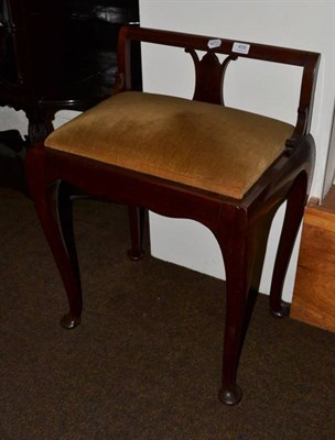 Lot 459 - A 1920's walnut music seat, with green overstuffed seat, cabriole legs and pad feet