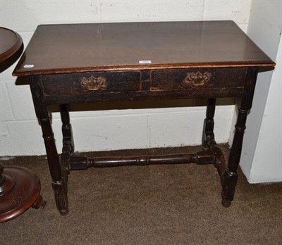 Lot 467 - An oak two drawer side table on turned block H stretcher