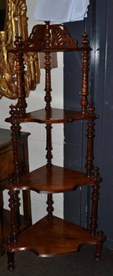 Lot 469 - A walnut four tier whatnot