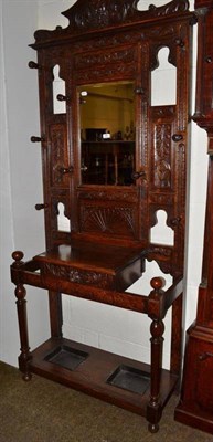 Lot 480 - 19th century oak hall stand, the upper section with bevelled mirror carved with masks, scroll...