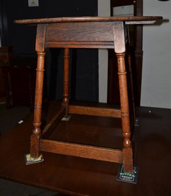 Lot 485 - An oak occasional table on four turned legs joined by stretchers