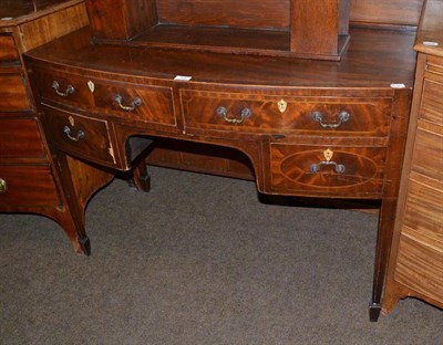 Lot 506 - An early 19th century mahogany bowfront dressing table on square section supports and spade feet