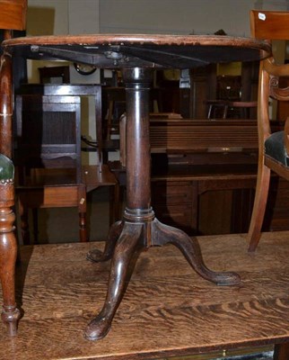 Lot 510 - A George III mahogany circular tripod table, on plain turned column support and triple out...