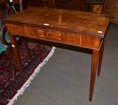 Lot 515 - A George III fold over tea table, with single frieze drawer, on square tapering supports