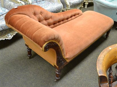 Lot 520 - A Victorian chaise with button back upholstery and turned feet with brass casters