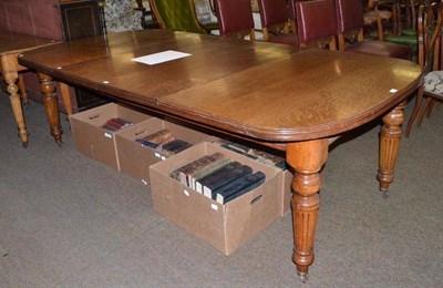 Lot 572 - Victorian oak extending dining table raised on castors