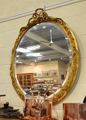 Lot 576 - An oval gilt framed wall mirror