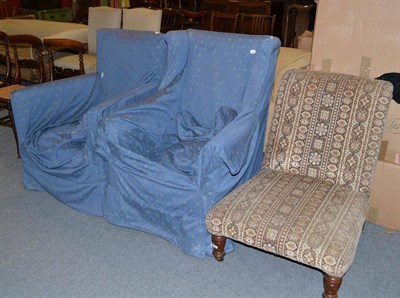 Lot 654 - An Edwardian upholstered nursing chair and two armchairs with loose blue covers