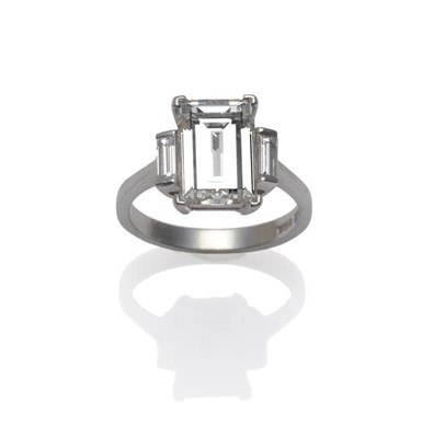 Lot 342 - A Platinum Diamond Ring, the central oblong step cut diamond with a smaller baguette cut each side