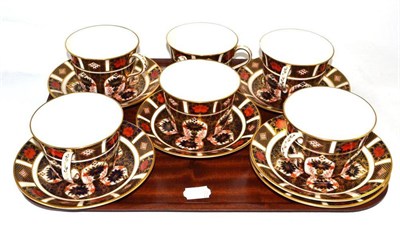 Lot 33 - A set of six Royal Crown Derby 1128 pattern breakfast cups and saucers (one saucer damaged)