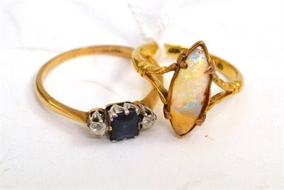 Lot 66 - An 18ct gold opal ring and a sapphire and diamond three stone ring