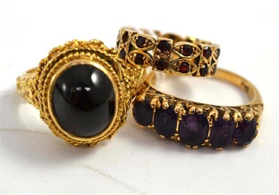 Lot 92 - A 9ct gold garnet set locket ring, a 9ct gold amethyst ring and a garnet set eternity ring...