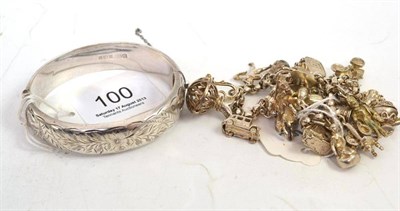 Lot 100 - A silver charm bracelet and a silver hollow bangle