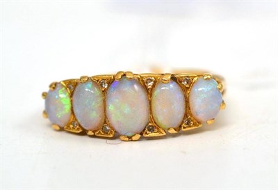 Lot 103 - An opal five stone ring with diamond accents