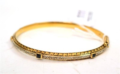 Lot 111 - A sapphire set bangle