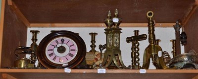 Lot 179 - A shelf of brass ware including candlesticks, fire dogs, kettles and a clock