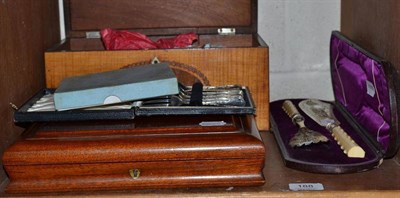 Lot 188 - Irish silver sugar nips, cased fish servers, various silver and plated flatware, with mahogany box