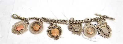 Lot 275 - A silver bracelet with T bar, hung with six shields and medals