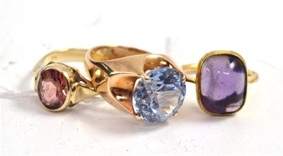 Lot 301 - An amethyst cabochon ring and two 9ct gold stone-set rings